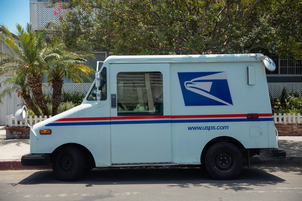 White Delivery Van Parked Near Green Tree